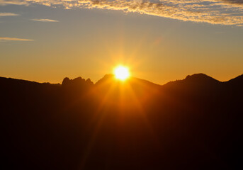 Sun setting behind mountains in Teide National Park