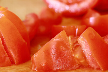 Bright close-up image of fresh cherry tomatoes on the vine with vibrant green leaves. Perfect for themes of healthy food, gardening, freshness, and cooking