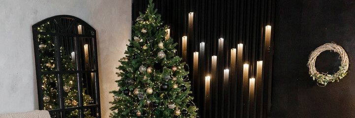 Bedroom interior decorated for Christmas holidays. Home interior with a Christmas tree on a dark wall background.