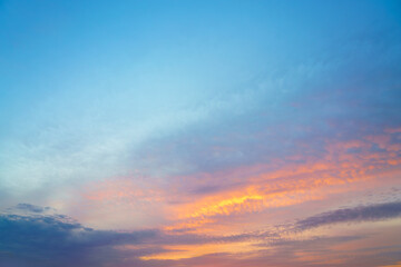 Beautiful sunset or sunrise sky with vibrant clouds changing from purple to orange is perfect for an abstract or nature background.