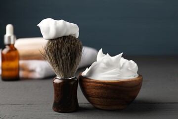 Different barber's tools on grey wooden table, closeup