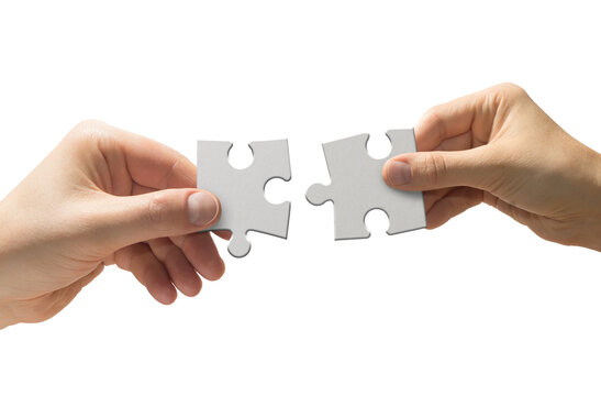 High quality PNG of close up two human hands hold white puzzle pieces. Teamwork concept. Isolated image on a transparent background