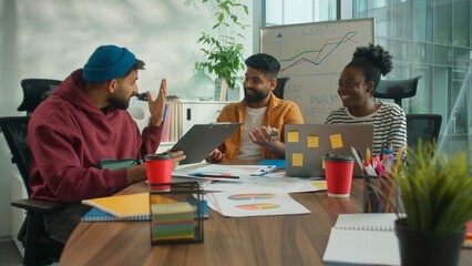 Three business informal diversity workers in meeting office happy success achieve data talking...