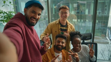 Business casual startup team in office meeting joy fun smiling making selfie photo together enjoying teamwork in friendly coworking posing for video call vlog take picture multiethnic four people