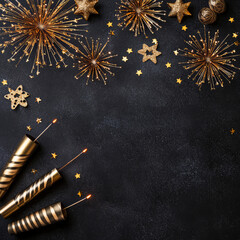 New Year composition with golden ornaments, champagne, and festive decorations arranged on a dark background. Seasonal banners, invitations, and holiday promotions.