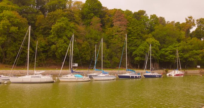 Sailboats docked at Saint-Goustan port, peaceful and scenic water scene