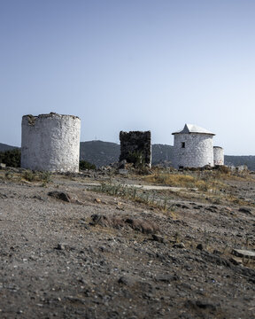 View of the old stone windmills standing stoically against the clear blue sky, remnants of a bygone era, in Bodrum, Mugla, Turkey.