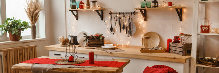 Cozy Christmas decorated kitchen and dining area with festive lights. Holiday home decor for winter celebration.