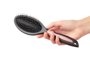 Woman hand holding hairbrush isolated on white background.