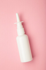 Nasal drops medicine bottle on pink background