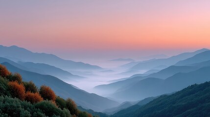 Obraz premium Serene Sunrise Over Misty Forested Hills with Golden Hues in the Sky and Gentle Blue Fog in the Valleys