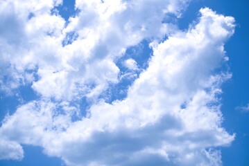 Fluffy white clouds against a vibrant blue sky backdrop.