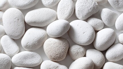 White pebbles creating a smooth and calming background for decorating, crafting, and design projects in various indoor and outdoor settings