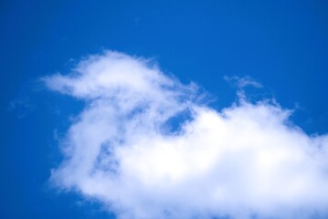 White cloud against a vibrant blue sky, a serene natural scene.