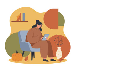 Cozy autumn scene Woman relaxing or working remotely on a tablet in a comfortable chair