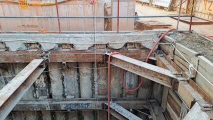 underground excavation site with steel bracing and retaining wall