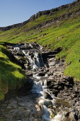 vertical view of the Kluftafossur waterfall near Haldarsvik village on Streymoy in the Faroe Islands