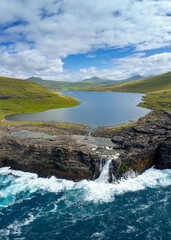 vertical view of Sorvagsvatn Lake and Bosdalafossur Waterfall on Vagar Island in the Faroe Islands © makasana photo
