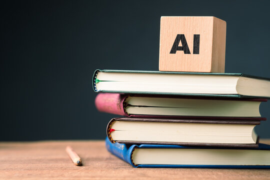 Wooden block with AI text placed on stacked books and pencil on table, symbolizing artificial intelligence in education, learning support, and knowledge creation through reading and writing