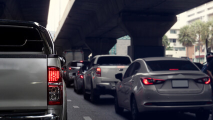 Rear side of pickup car siver color with turn on brake light. Traffic jam in the city with cars on...