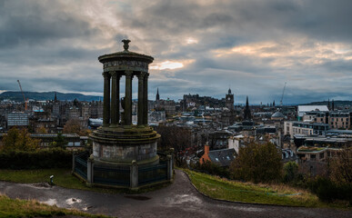 Late autumn evening view from Calton Hill overlooking Edinburgh, with the city bathed in soft...