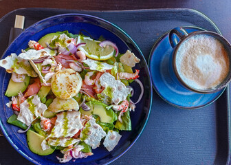 A wonderful salad with seared scallops, shrimp, cherry tomatoes, red onion and herbs