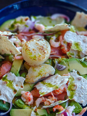 A wonderful salad with seared scallops, shrimp, cherry tomatoes, red onion and herbs
