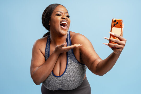 Plus size Black woman laughing during a video call