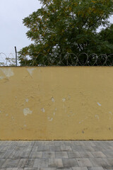 Texture of a brick wall with old, peeling paint in some partially ruined buildings