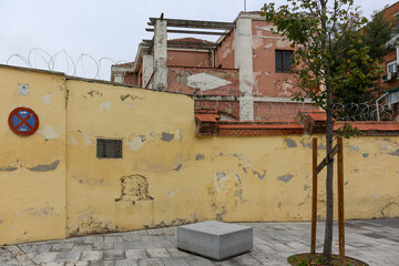 Texture of a brick wall with old, peeling paint in some partially ruined buildings
