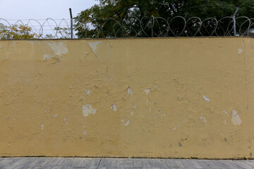 Texture of a brick wall with old, peeling paint in some partially ruined buildings