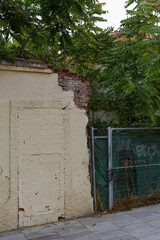 Texture of a brick wall with old, peeling paint in some partially ruined buildings