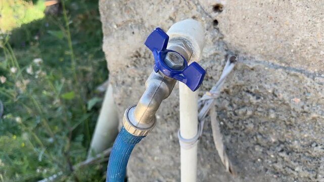 An old faucet with a hose attached