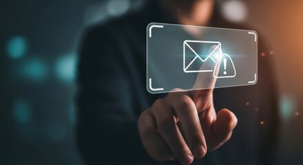 A businessman's finger touches a futuristic virtual screen interface with a warning alert for an incoming spam email or phishing scam