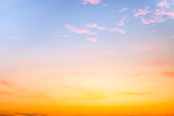 Obraz premium Sunset or sunrise sky with a vibrant gradient of orange, gold, and soft blue. Clear atmosphere with wispy clouds. Peaceful, natural light background. hope, freedom, new day and inspirational Concepts
