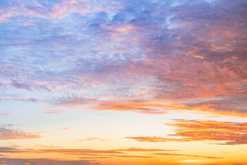 Sunset or sunrise sky with a vibrant gradient of orange, gold, and soft blue. Clear atmosphere with wispy clouds. Peaceful, natural light background. hope, freedom, new day and inspirational Concepts
