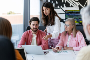 Group of smiling businessman and businesswomen together working in modern office, planning project