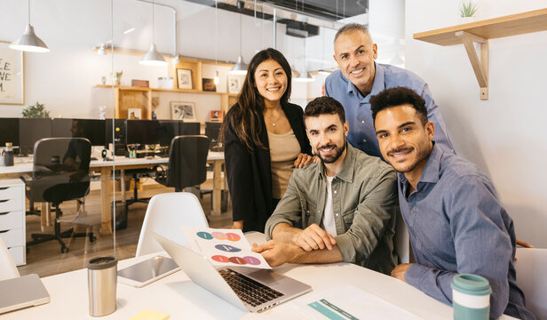 Diverse startup team collaborating in modern office setting - Powered by Adobe