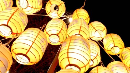 Cluster of yellow lanterns illuminating a sparkling atmosphere.