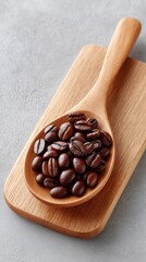 Obraz premium Dark Roasted Coffee Beans Piled On A Wooden Spoon Set On A Light Wooden Board With A Textured Gray Background Detailed Top Down View