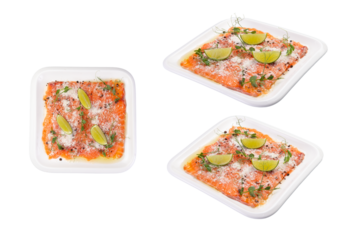 Salmon carpaccio with lemon wedges on a plate. Transparent