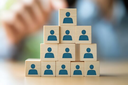 Team Hierarchy Concept: Wooden blocks, artfully arranged, illustrate a clear business structure. The image emphasizes organizational principles and leadership roles. 