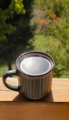 Outdoor Coffee Break: Light Reflection on the Mug