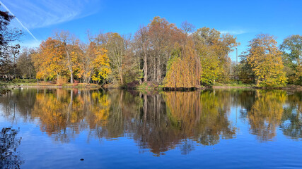 Trees mirrored in the clear blue Lake with good weather. High quality photo