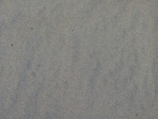 Intricate texture of fine sand revealing subtle variations in grain and color, perfect for natural backgrounds and design elements.