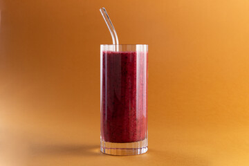 Smoothie in a glass on a yellow background.