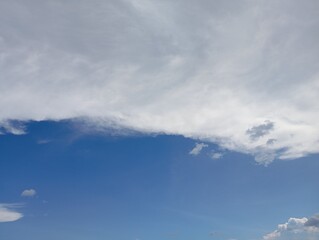 Vast blue sky meets soft white clouds creating a serene, airy backdrop for your next project