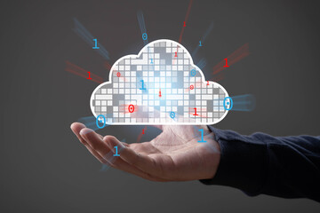 Cloud computing technology concept with binary code floating around a digital cloud icon above a hand, symbolizing data storage, online access, and network computing solutions.