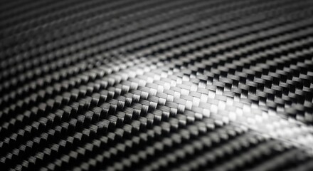 Close-up macro detail of a black carbon fiber surface with intricate woven texture and high-tech appearance.