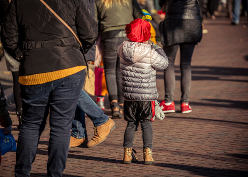A young child dressed in costume waits excitedly for Saint Nicholas to arrive on his white horse, Amerigo, during the traditional Sinterklaas festivities in Dordrecht.